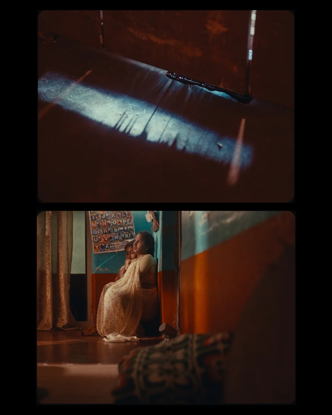 A sliver of daylight in a dark red-lit room; below, a figure seated against a poster-covered wall.